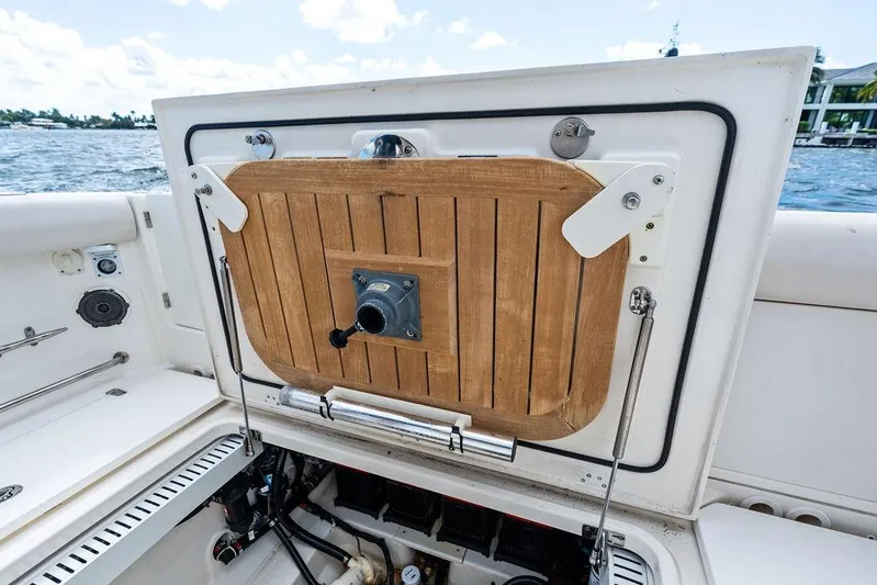  Yacht Photos Pics 2018 Boston Whaler 330 Outrage boat hatch open, revealing interior components.