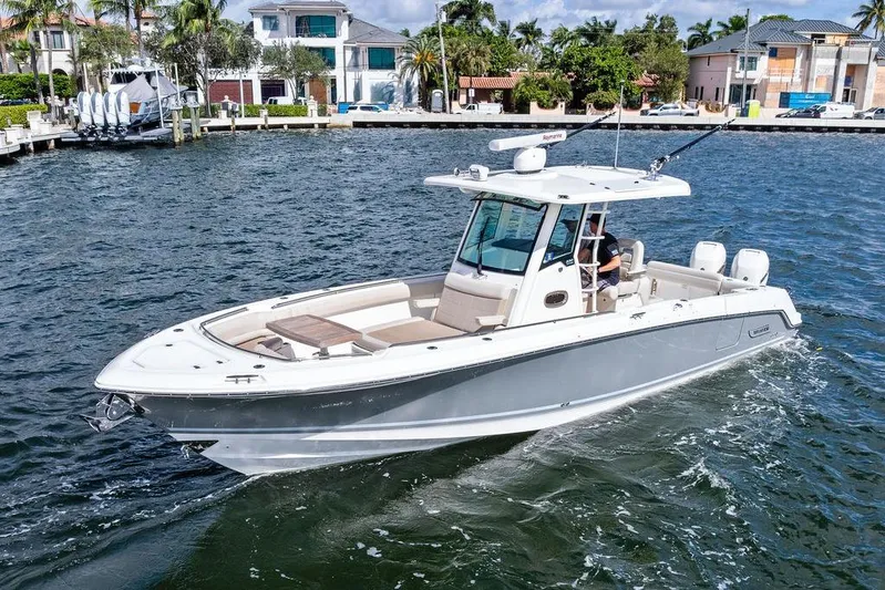  Yacht Photos Pics 2018 Boston Whaler 330 Outrage boat cruising on a scenic waterfront.