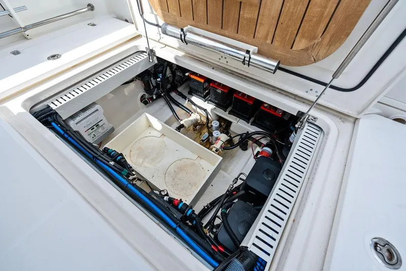  Yacht Photos Pics 2018 Boston Whaler 330 Outrage boat storage compartment with equipment and wiring.