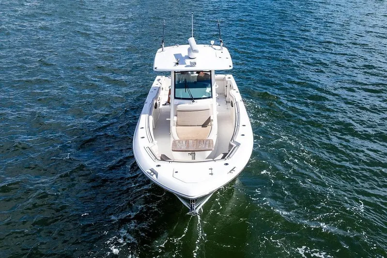  Yacht Photos Pics 2018 Boston Whaler 330 Outrage boat cruising on open water.