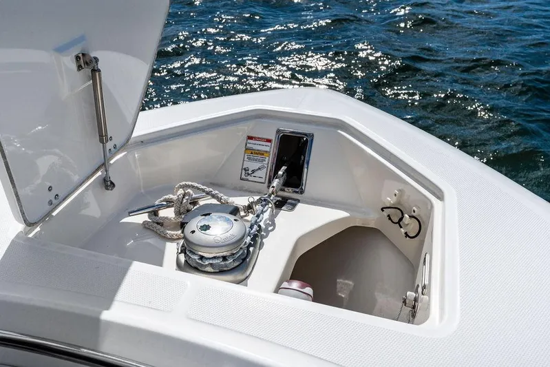  Yacht Photos Pics 2018 Boston Whaler 330 Outrage anchor compartment with rope, open on calm water.