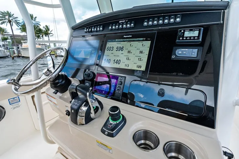  Yacht Photos Pics Control panel of a 2018 Boston Whaler 330 Outrage boat with navigation screens.