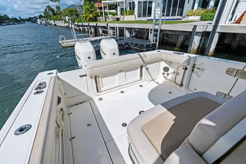 Yacht Photos Pics 2018 Boston Whaler 330 Outrage boat interior with dual engines, docked by waterfront homes.