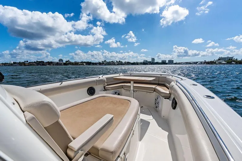  Yacht Photos Pics 2018 Boston Whaler 330 Outrage boat on sunny waters with clear skies.