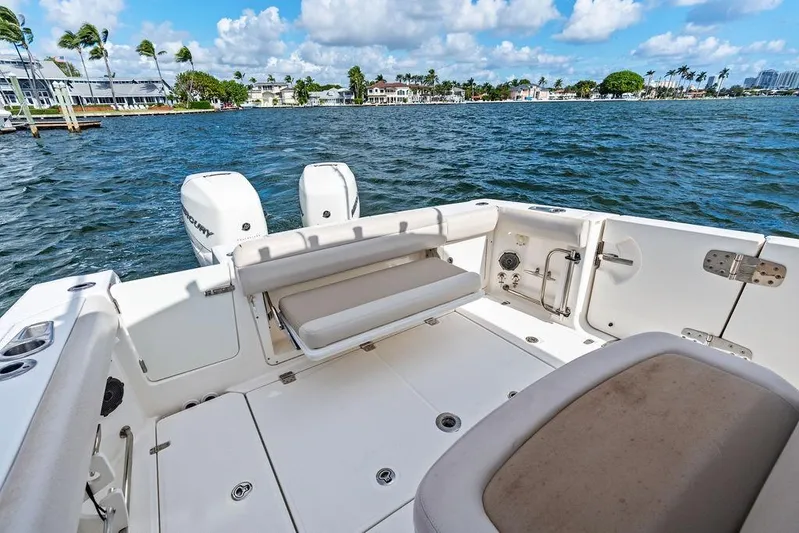  Yacht Photos Pics 2018 Boston Whaler 330 Outrage boat with dual Mercury engines on a sunny day.