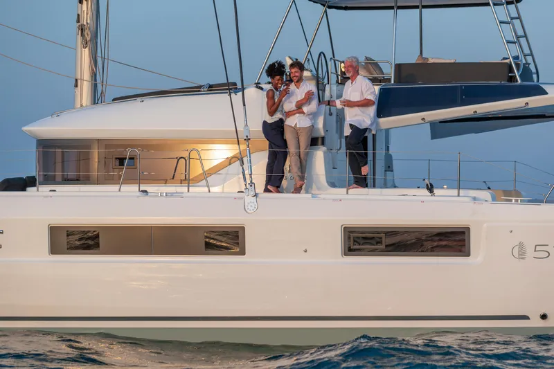 Yacht Photos Pics 2024 Lagoon 51 yacht with people enjoying a sunset cruise.