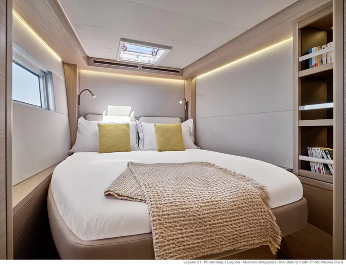  Yacht Photos Pics Luxurious cabin interior of 2024 Lagoon 51 yacht with cozy bed and modern design.