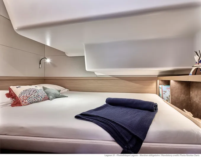  Yacht Photos Pics Luxurious cabin interior of 2024 Lagoon LAGOON 51 yacht with cozy bedding and modern design.