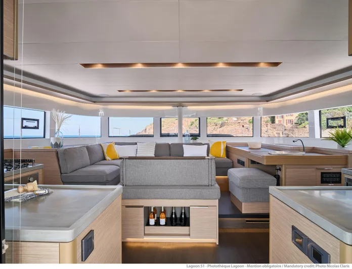  Yacht Photos Pics Luxurious interior of 2024 Lagoon 51 yacht with modern furnishings and panoramic windows.