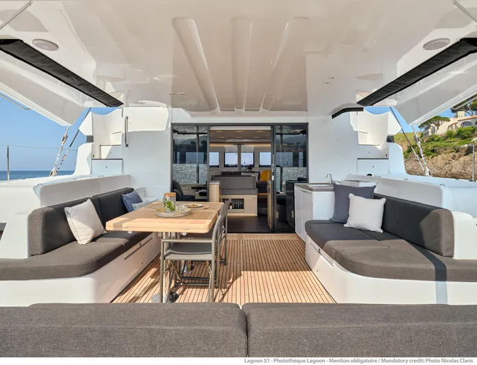  Yacht Photos Pics 2024 Lagoon 51 yacht interior with spacious seating and dining area.