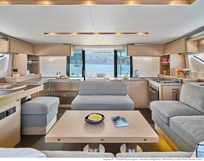  Yacht Photos Pics Luxurious interior of 2024 Lagoon 51 yacht with modern kitchen and seating area.