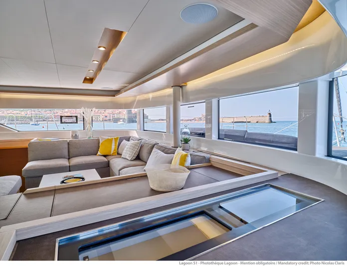  Yacht Photos Pics Luxurious interior of 2024 Lagoon LAGOON 51 yacht with panoramic windows and modern seating.