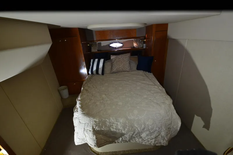 Seeking Sara Yacht Photos Pics Interior cabin of 2003 Cruisers Yachts 4370 Express with cozy bed and pillows.