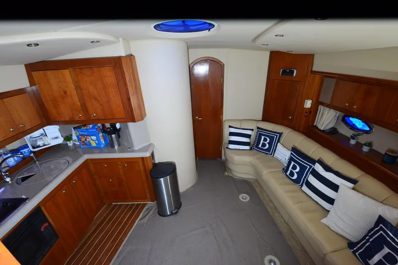 Seeking Sara Yacht Photos Pics Interior of 2003 Cruisers Yachts 4370 Express with kitchen and cozy seating area.