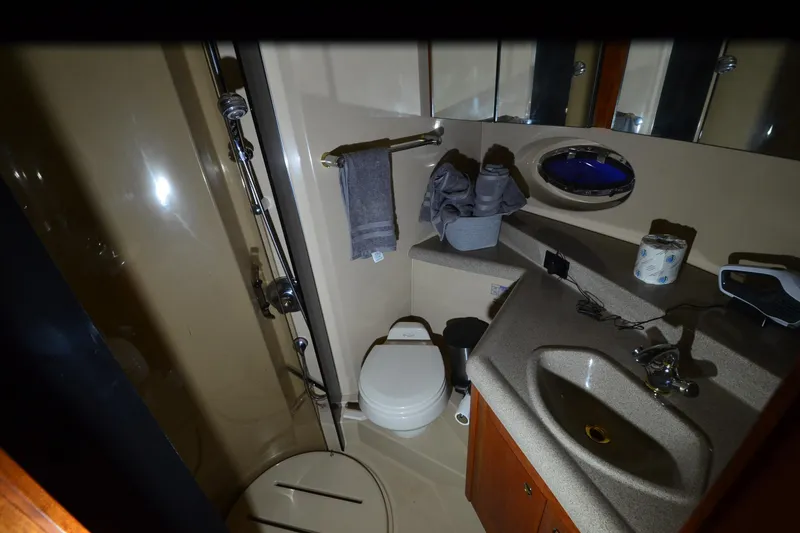 Seeking Sara Yacht Photos Pics Bathroom interior of 2003 Cruisers Yachts 4370 Express with shower, sink, and toilet.