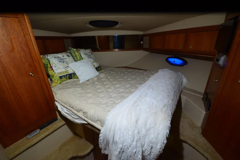 Seeking Sara Yacht Photos Pics Luxurious cabin interior of 2003 Cruisers Yachts 4370 Express with cozy bedding.