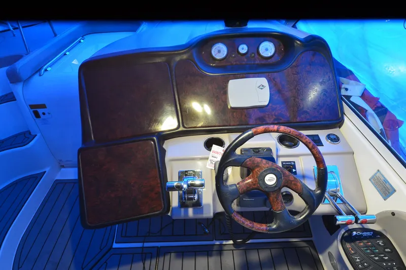 Seeking Sara Yacht Photos Pics 2003 Cruisers Yachts 4370 Express helm with wood accents and modern controls.