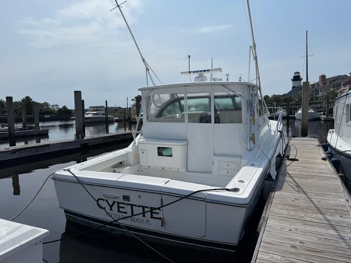 Cyette Yacht Photos Pics 2003 Pursuit 3800 Express boat docked at marina, rear view.