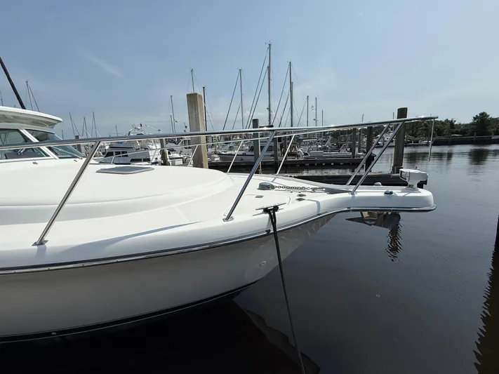 Cyette Yacht Photos Pics 2003 Pursuit 3800 Express boat docked at marina, calm water, clear sky.