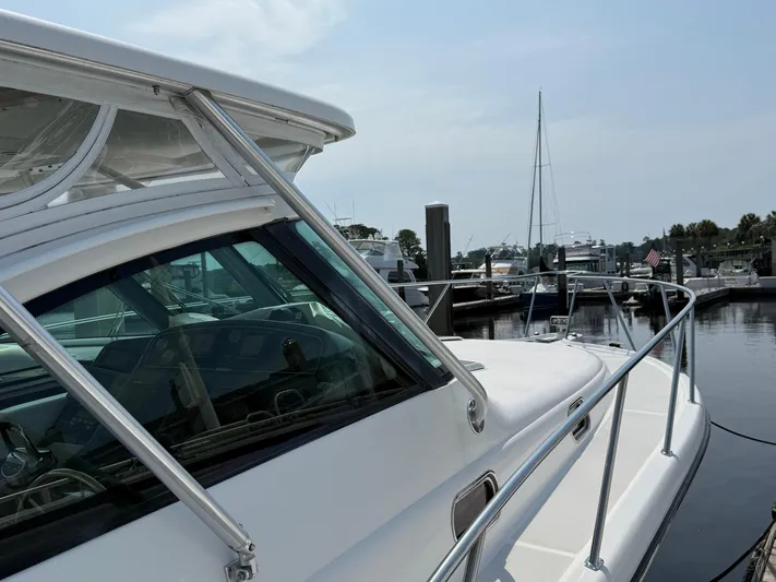 Cyette Yacht Photos Pics 2003 Pursuit 3800 Express boat docked at a marina on a sunny day.