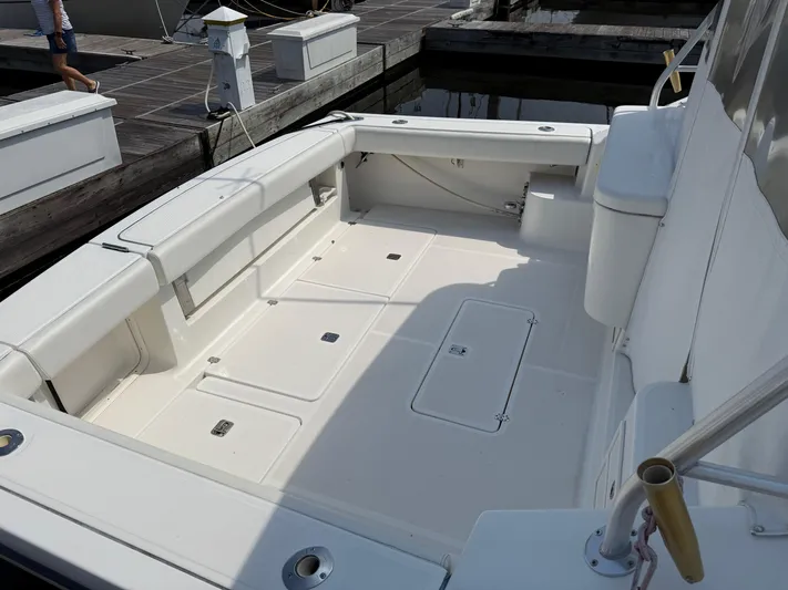 Cyette Yacht Photos Pics 2003 Pursuit 3800 Express boat deck, spacious and clean, docked at marina.