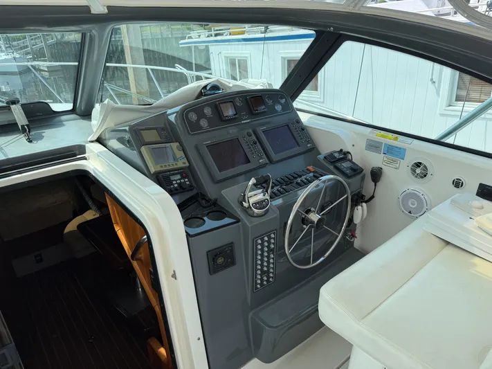 Cyette Yacht Photos Pics 2003 Pursuit 3800 Express boat helm with navigation equipment and steering wheel.