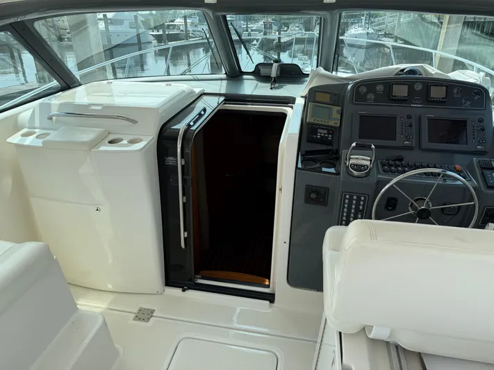Cyette Yacht Photos Pics 2003 Pursuit 3800 Express boat cockpit with steering wheel and navigation controls.
