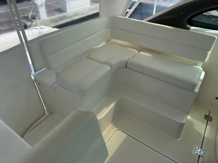 Cyette Yacht Photos Pics 2003 Pursuit 3800 Express boat interior with white cushioned seating.