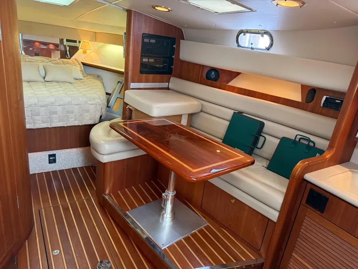 Cyette Yacht Photos Pics 2003 Pursuit 3800 Express yacht interior with wood finishes and cozy seating area.