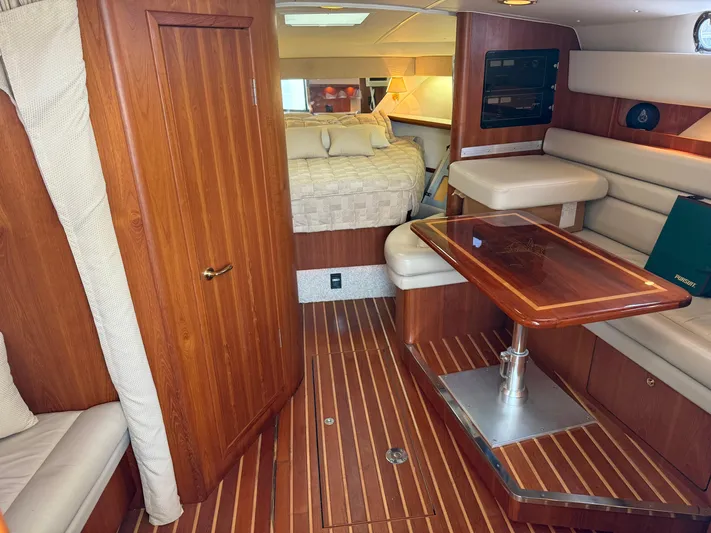 Cyette Yacht Photos Pics Luxurious 2003 Pursuit 3800 Express yacht interior with wood finishes and cozy seating area.