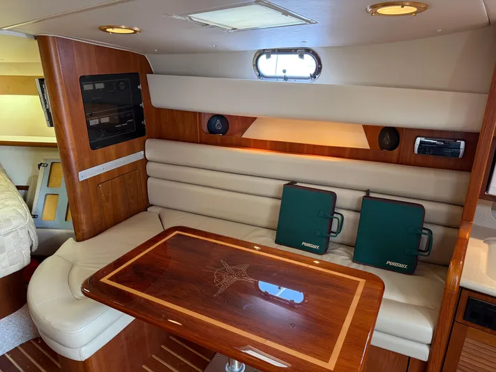 Cyette Yacht Photos Pics Luxurious interior of 2003 Pursuit 3800 Express yacht with elegant wood and leather seating.