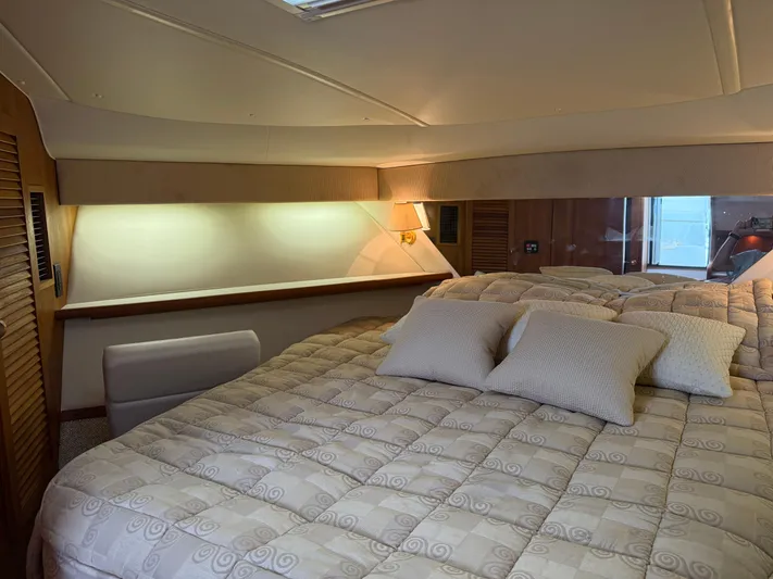 Cyette Yacht Photos Pics Luxurious cabin interior of 2003 Pursuit 3800 Express yacht with cozy bedding.