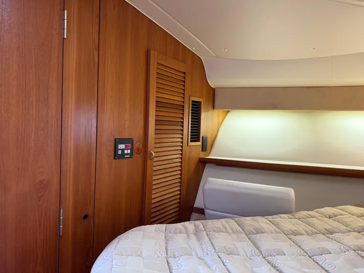 Cyette Yacht Photos Pics Interior of 2003 Pursuit 3800 Express yacht with wood paneling and cozy bed.