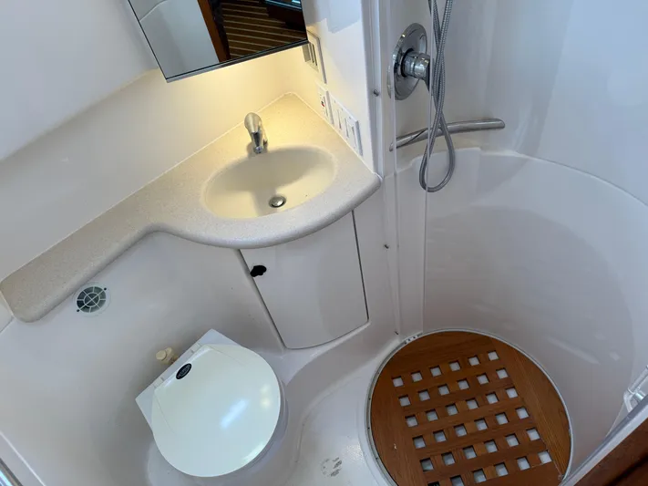 Cyette Yacht Photos Pics 2003 Pursuit 3800 Express yacht bathroom with sink, toilet, and shower area.