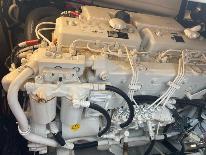 Cyette Yacht Photos Pics Engine of a 2003 Pursuit 3800 Express boat, showcasing intricate mechanical components.