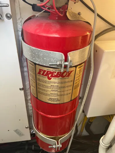 Cyette Yacht Photos Pics Red Fireboy fire extinguisher mounted on a 2003 Pursuit 3800 Express boat.