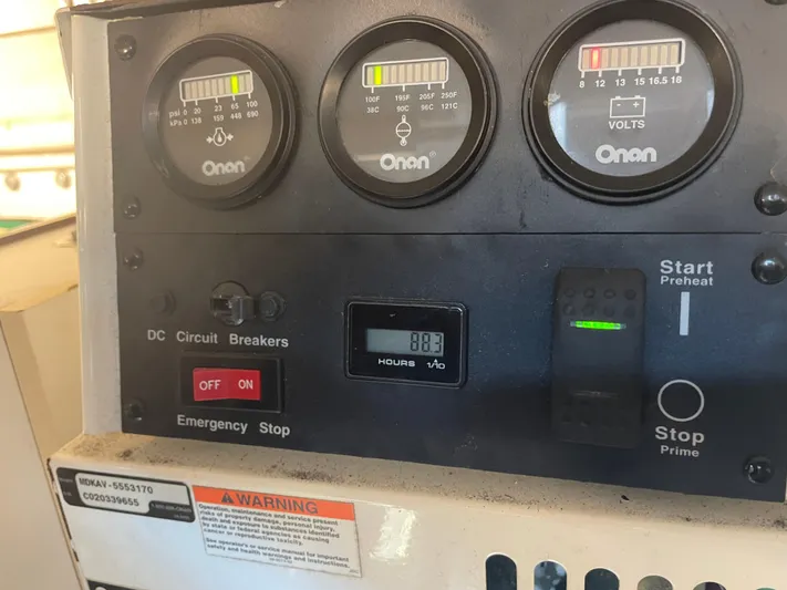 Cyette Yacht Photos Pics Control panel of a 2003 Pursuit 3800 Express boat with Onan gauges and emergency stop.