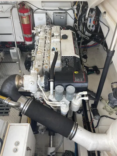 Cyette Yacht Photos Pics Engine room of a 2003 Pursuit 3800 Express boat, featuring detailed mechanical components.