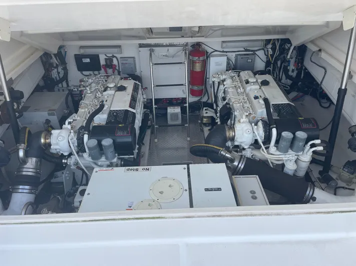 Cyette Yacht Photos Pics Engine room of a 2003 Pursuit 3800 Express boat, featuring dual engines and equipment.