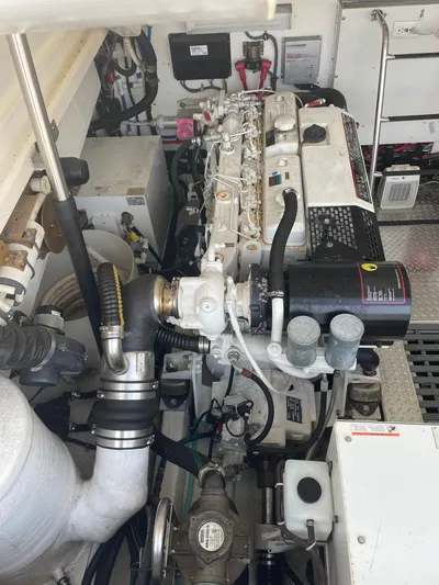 Cyette Yacht Photos Pics Engine room of a 2003 Pursuit 3800 Express boat, showcasing mechanical components.