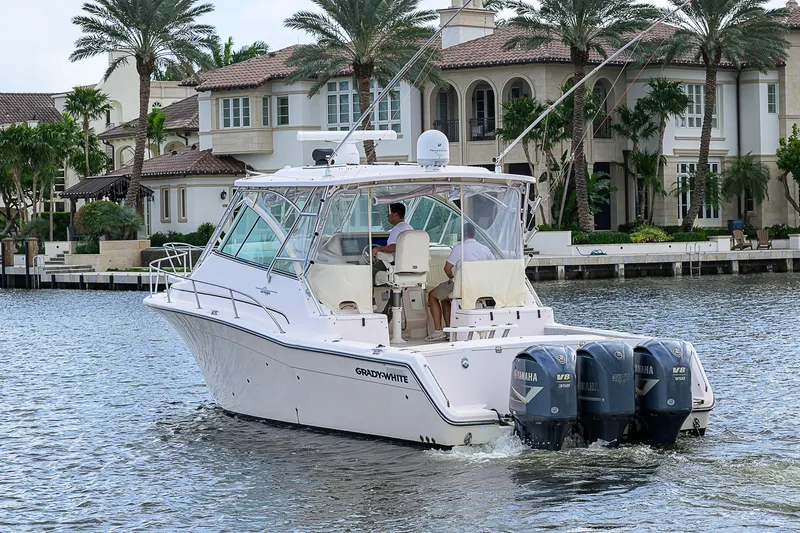  Yacht Photos Pics 2008 Grady-White Express 360 boat cruising near waterfront homes.