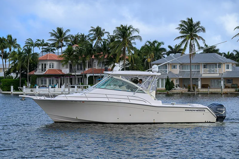  Yacht Photos Pics 2008 Grady-White Express 360 boat on water, with palm trees and houses in the background.