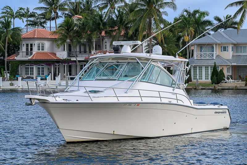 Yacht Photos Pics 2008 Grady-White Express 360 boat on water, with luxury homes and palm trees in the background.