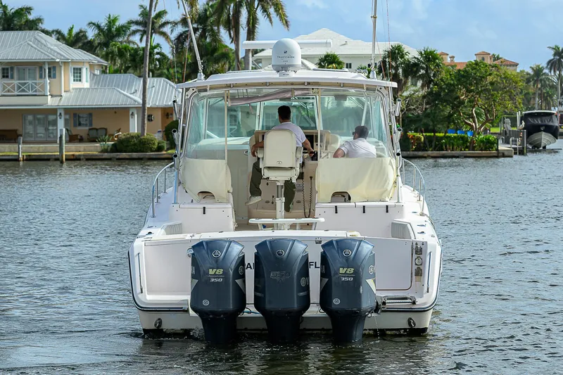  Yacht Photos Pics 2008 Grady-White Express 360 boat with triple outboard engines on a calm waterway.