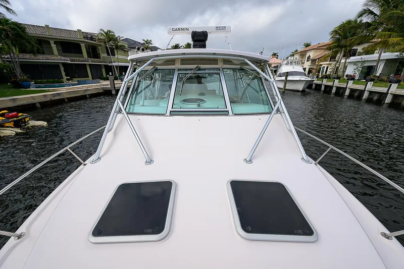  Yacht Photos Pics 2008 Grady-White Express 360 boat docked in a canal, showcasing sleek design and spacious deck.