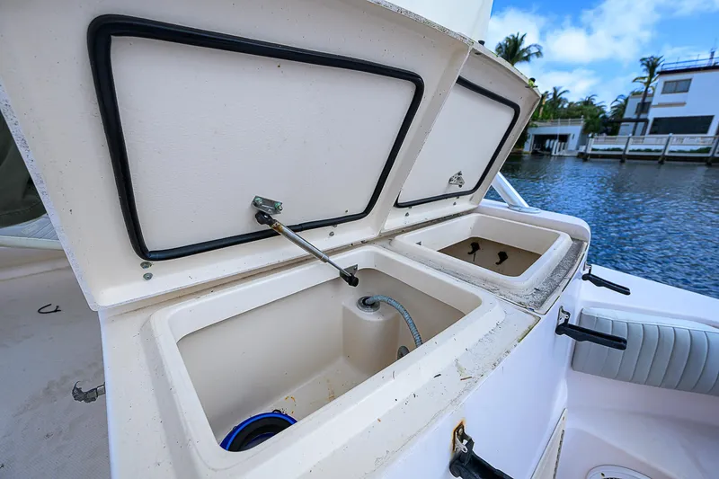  Yacht Photos Pics Open storage compartments on 2008 Grady-White Express 360 boat by the water.