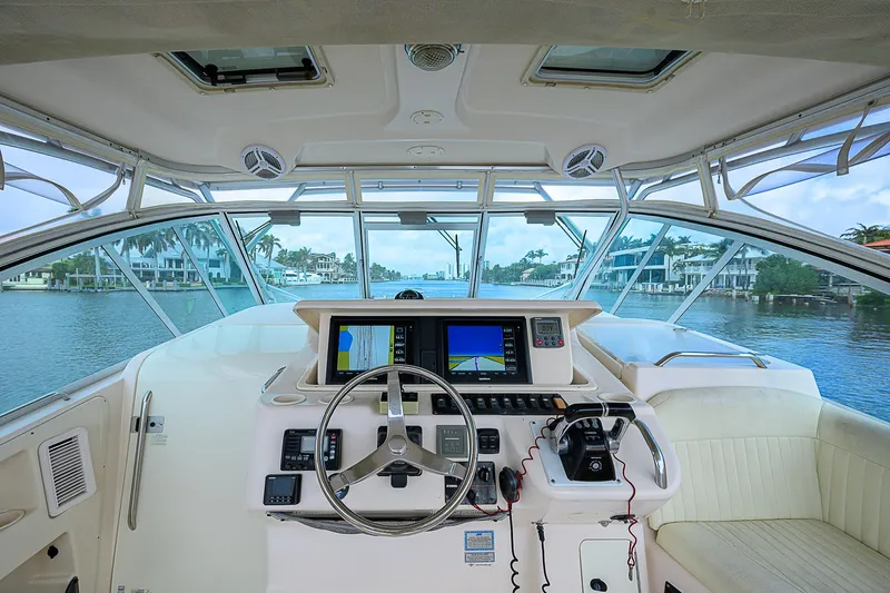  Yacht Photos Pics 2008 Grady-White Express 360 helm with navigation screens and steering wheel, overlooking waterfront.