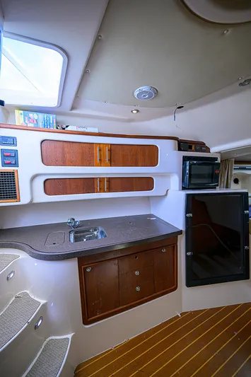  Yacht Photos Pics 2008 Grady-White Express 360 cabin interior with kitchenette and wood accents.