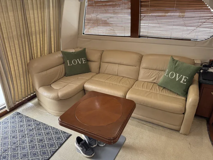  Yacht Photos Pics Luxurious interior of 2000 Carver 450 Voyager Pilothouse with beige leather sofa and "Love" pillows.