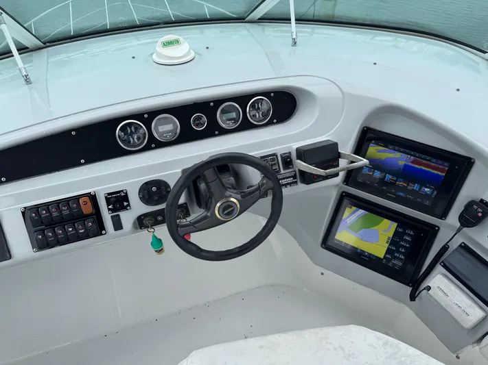  Yacht Photos Pics Pilothouse of 2000 Carver 450 Voyager with steering wheel, gauges, and navigation screens.